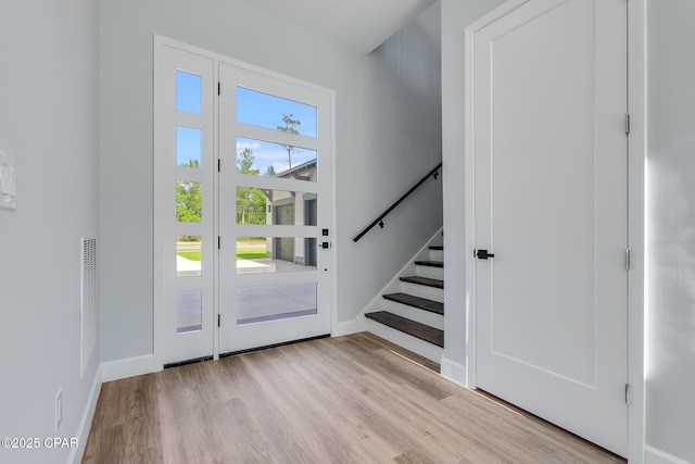 12809 Merial Green Way, Southport, FL 32409 - foyer featuring wood finished floors, baseboards, and stairs