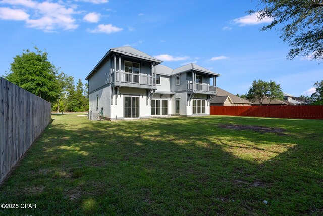 12809 Merial Green Way, Southport, FL 32409 - rear view of house featuring a balcony