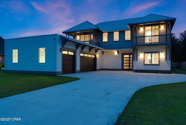 12809 Merial Green Way, Southport, FL 32409 - view of front of property with a balcony, concrete driveway, stucco siding, and a front lawn