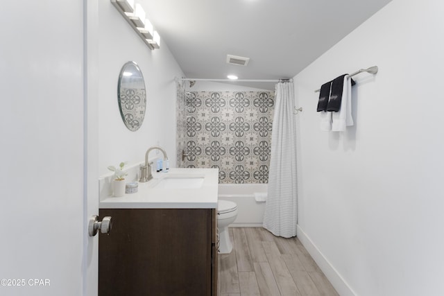 13826 Front Beach Rd, Panama City Beach, FL 32413 - full bathroom featuring shower / bathtub combination with curtain, toilet, vanity, wood finished floors, and baseboards