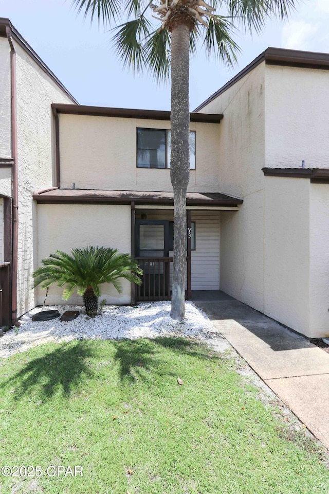 17620 Front Beach Rd Unit Y3, Panama City Beach, FL 32413 - view of property with stucco siding and a front yard