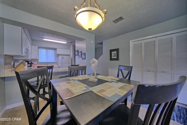 17620 Front Beach Rd Unit Y3, Panama City Beach, FL 32413 - dining space with a textured ceiling