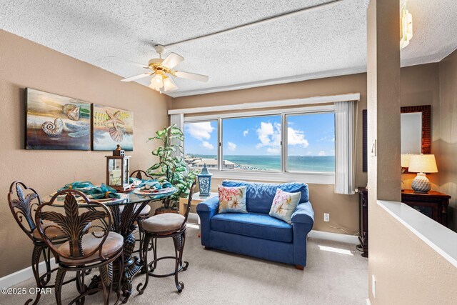 23223 Front Beach Rd Unit A509, Panama City Beach, FL 32413 - carpeted dining room with a ceiling fan, baseboards, a textured ceiling, and a water view