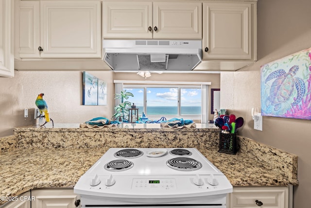23223 Front Beach Rd Unit A509, Panama City Beach, FL 32413 - kitchen featuring under cabinet range hood, range with electric cooktop, white cabinetry, a water view, and light stone countertops