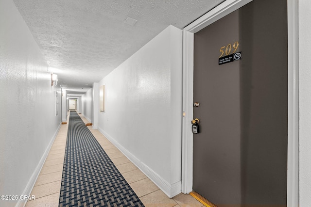 23223 Front Beach Rd Unit A509, Panama City Beach, FL 32413 - hallway featuring a textured ceiling and light tile patterned floors