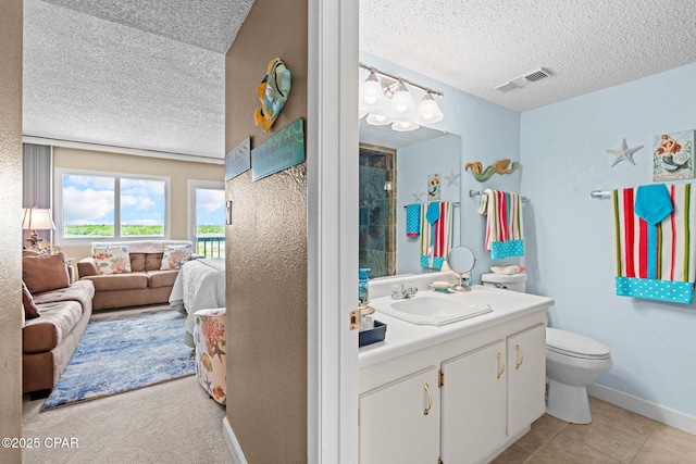 23223 Front Beach Rd Unit A509, Panama City Beach, FL 32413 - ensuite bathroom featuring a textured ceiling, vanity, toilet, and baseboards