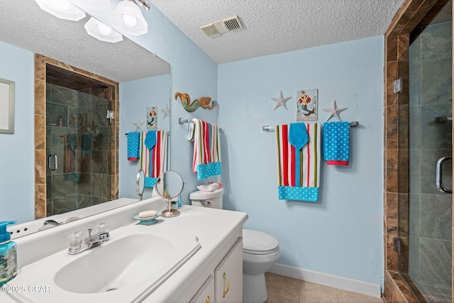 23223 Front Beach Rd Unit A509, Panama City Beach, FL 32413 - full bath with a shower stall, tile patterned flooring, vanity, a textured ceiling, and toilet