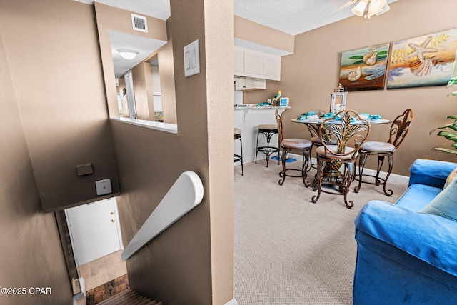 23223 Front Beach Rd Unit A509, Panama City Beach, FL 32413 - dining area featuring baseboards, light colored carpet, and a textured ceiling