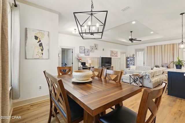3928 Sandpine Way, Panama City, FL 32404 - dining room with a raised ceiling, a chandelier, baseboards, light wood-style floors, and recessed lighting