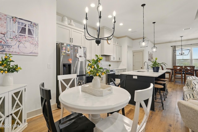 3928 Sandpine Way, Panama City, FL 32404 - dining room with light wood-type flooring, recessed lighting, ornamental molding, a chandelier, and baseboards