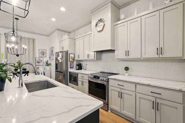 3928 Sandpine Way, Panama City, FL 32404 - kitchen featuring stainless steel appliances, a sink, tasteful backsplash, hanging light fixtures, and recessed lighting