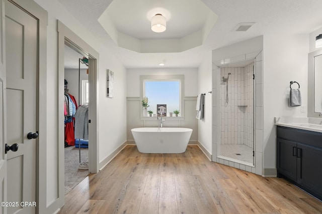3928 Sandpine Way, Panama City, FL 32404 - bathroom with a stall shower, hardwood / wood-style flooring, vanity, and a freestanding bath