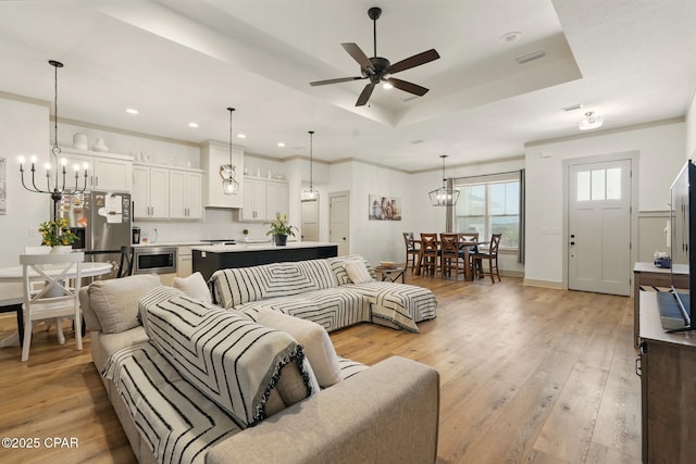 3928 Sandpine Way, Panama City, FL 32404 - living area with light wood-type flooring, a raised ceiling, ceiling fan, recessed lighting, and a chandelier
