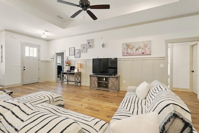 3928 Sandpine Way, Panama City, FL 32404 - living area with ceiling fan, light wood-style flooring, wainscoting, and a decorative wall