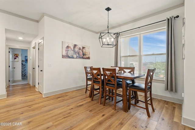 3928 Sandpine Way, Panama City, FL 32404 - dining area featuring light wood finished floors, a chandelier, and baseboards