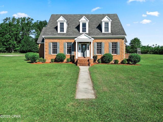 18562 Lois Fowler Rd, Blountstown, FL 32424 - cape cod house featuring brick siding, a front lawn, and roof with shingles