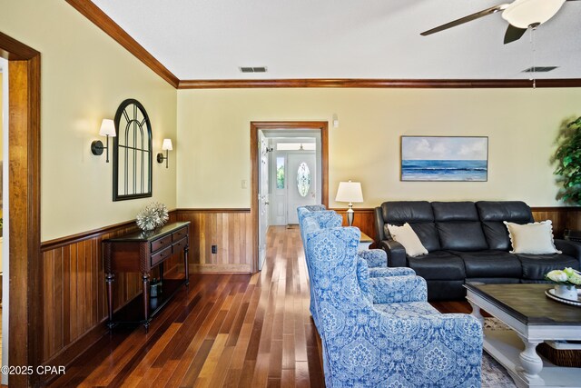18562 Lois Fowler Rd, Blountstown, FL 32424 - living area featuring a wainscoted wall, dark wood-style floors, ornamental molding, a ceiling fan, and wood walls