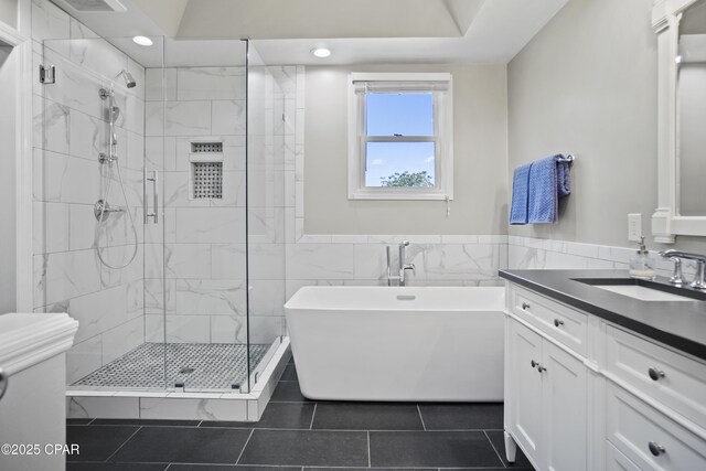 18562 Lois Fowler Rd, Blountstown, FL 32424 - full bathroom with a stall shower, tile patterned flooring, a freestanding bath, recessed lighting, and tile walls