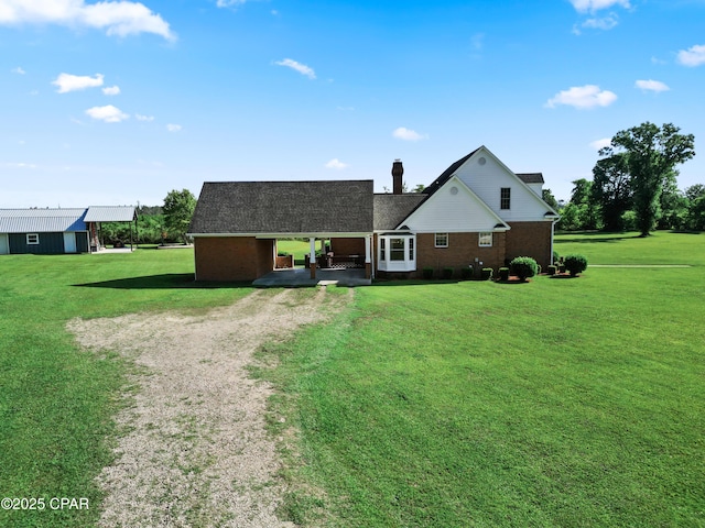 18562 Lois Fowler Rd, Blountstown, FL 32424 - view of front of property featuring driveway, a front lawn, and brick siding