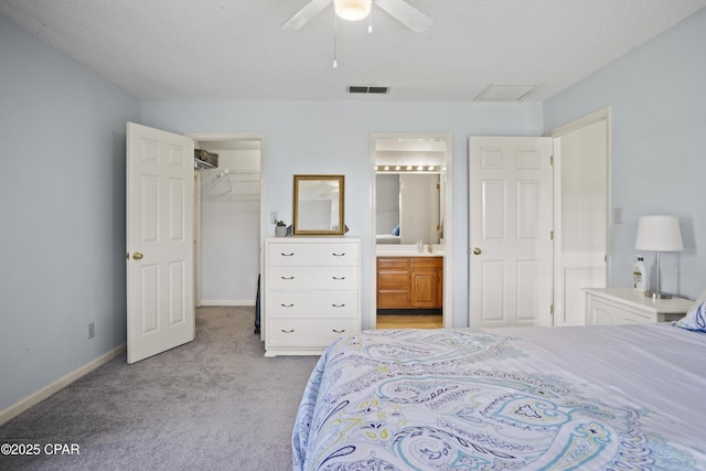 18562 Lois Fowler Rd, Blountstown, FL 32424 - bedroom featuring a walk in closet, light carpet, ensuite bath, baseboards, and a closet