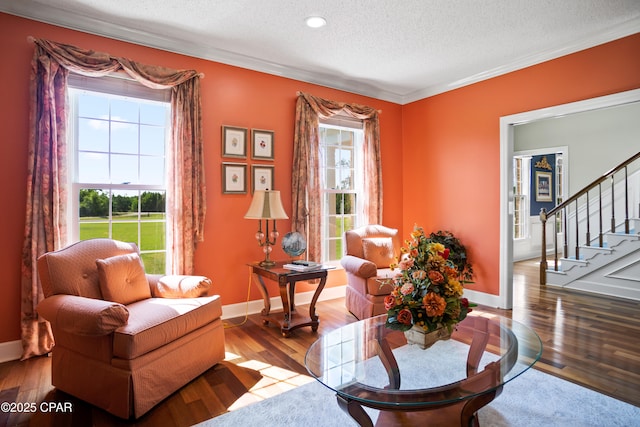 18562 Lois Fowler Rd, Blountstown, FL 32424 - sitting room featuring stairs, hardwood / wood-style floors, a textured ceiling, ornamental molding, and baseboards