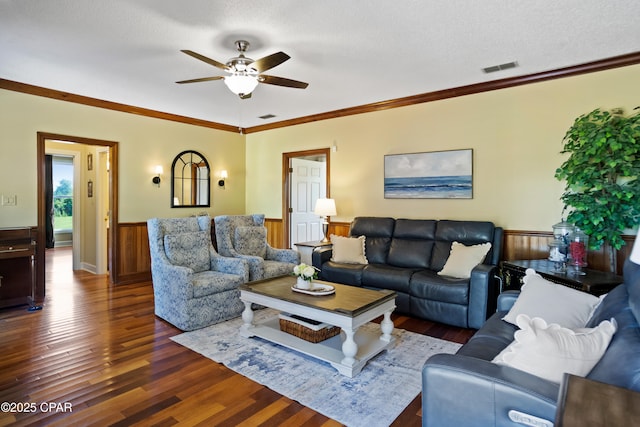 18562 Lois Fowler Rd, Blountstown, FL 32424 - living room with dark wood-style flooring, a wainscoted wall, ceiling fan, crown molding, and a textured ceiling