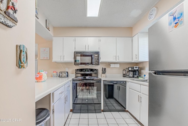 17620 Front Beach Rd Unit 2V, Panama City Beach, FL 32413 - kitchen with black appliances, white cabinets, light countertops, light tile patterned floors, and a textured ceiling