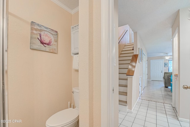 17620 Front Beach Rd Unit 2V, Panama City Beach, FL 32413 - stairway with tile patterned flooring, crown molding, a ceiling fan, baseboards, and a textured ceiling