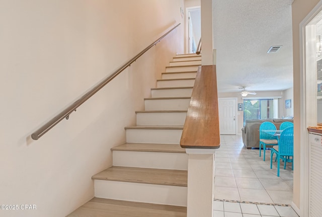 17620 Front Beach Rd Unit 2V, Panama City Beach, FL 32413 - stairway with a textured ceiling, ceiling fan, and tile patterned flooring