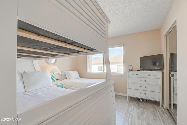 17620 Front Beach Rd Unit 2V, Panama City Beach, FL 32413 - bedroom featuring wood finished floors, a textured ceiling, and baseboards