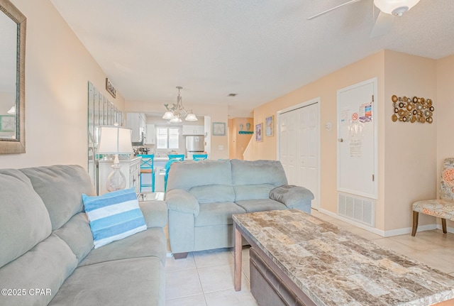 17620 Front Beach Rd Unit 2V, Panama City Beach, FL 32413 - living area featuring light tile patterned floors, a chandelier, ceiling fan, baseboards, and a textured ceiling