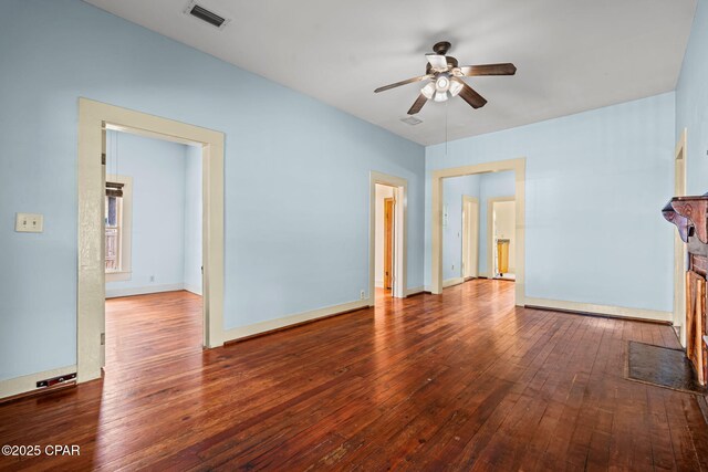 208 N E Ave, Panama City, FL 32401 - unfurnished living room featuring a ceiling fan, hardwood / wood-style floors, and baseboards