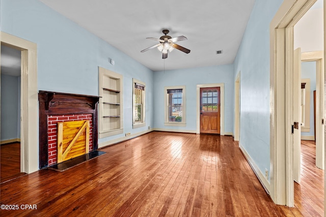 208 N E Ave, Panama City, FL 32401 - unfurnished living room with a ceiling fan, hardwood / wood-style floors, built in features, and baseboards