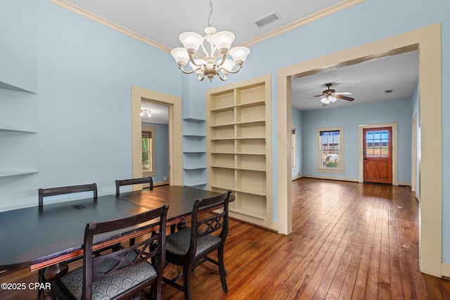 208 N E Ave, Panama City, FL 32401 - dining room with a chandelier, healthy amount of natural light, built in features, ornamental molding, and hardwood / wood-style floors