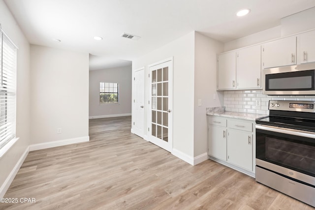 4130 White Pine Ct, Tallahassee, FL 32311 - kitchen with appliances with stainless steel finishes, baseboards, light wood-type flooring, decorative backsplash, and recessed lighting