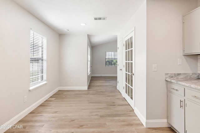 4130 White Pine Ct, Tallahassee, FL 32311 - kitchen with baseboards, light wood-style flooring, recessed lighting, and white cabinets