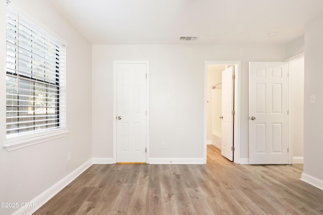4130 White Pine Ct, Tallahassee, FL 32311 - unfurnished bedroom with light wood finished floors and baseboards