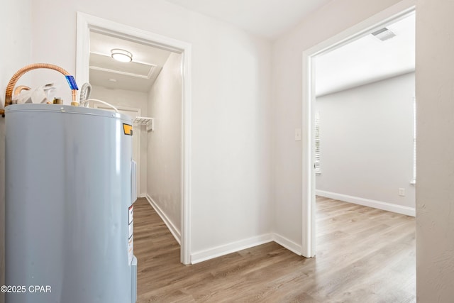 4130 White Pine Ct, Tallahassee, FL 32311 - hallway featuring water heater, attic access, light wood finished floors, and baseboards