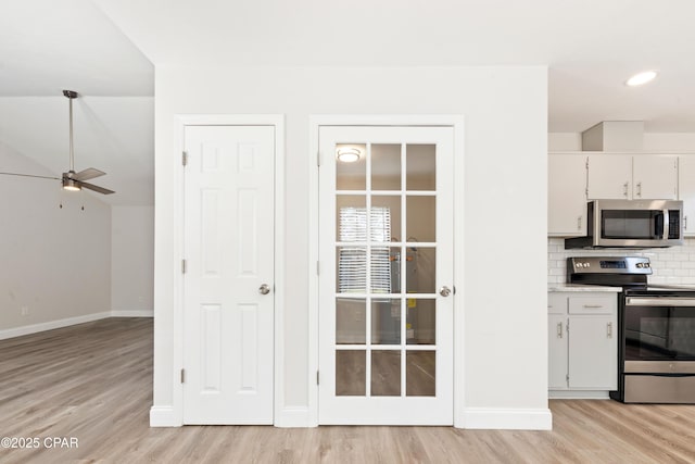 4130 White Pine Ct, Tallahassee, FL 32311 - kitchen featuring appliances with stainless steel finishes, light wood finished floors, ceiling fan, and tasteful backsplash