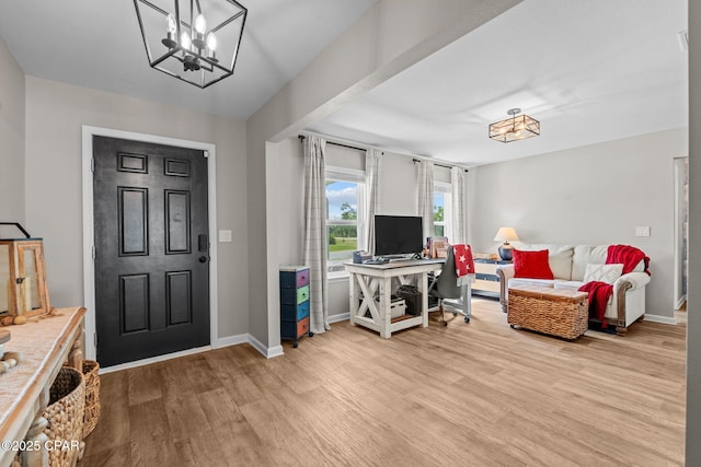 160 James Way, Southport, FL 32409 - foyer featuring light wood-style flooring, a chandelier, and baseboards
