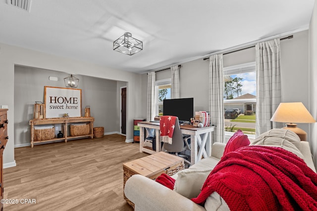 160 James Way, Southport, FL 32409 - living room featuring baseboards and wood finished floors