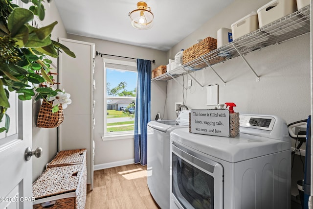160 James Way, Southport, FL 32409 - laundry room featuring washing machine and dryer, light wood finished floors, and baseboards