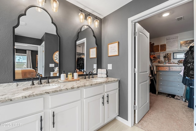 160 James Way, Southport, FL 32409 - full bathroom with double vanity, a walk in closet, and ensuite bathroom