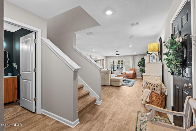 160 James Way, Southport, FL 32409 - staircase featuring baseboards, wood finished floors, a ceiling fan, and recessed lighting