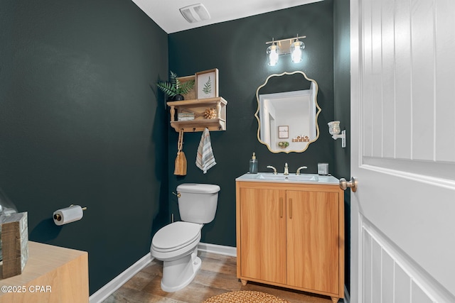 160 James Way, Southport, FL 32409 - half bath featuring toilet, wood finished floors, vanity, and baseboards