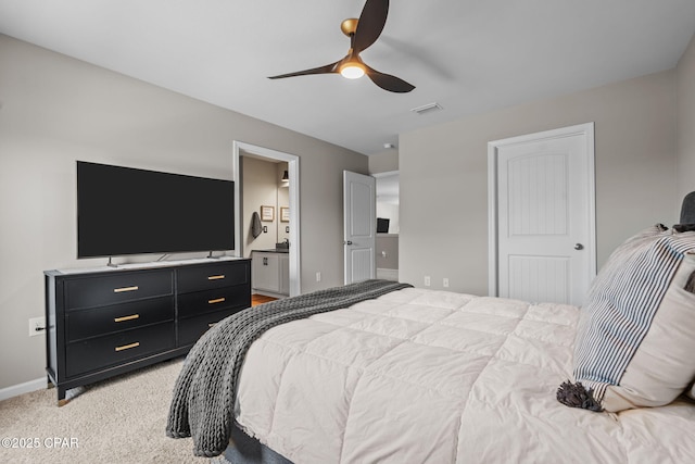 160 James Way, Southport, FL 32409 - bedroom with baseboards, light colored carpet, a ceiling fan, and ensuite bathroom