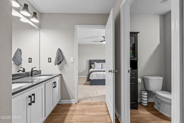 160 James Way, Southport, FL 32409 - bathroom featuring wood finished floors, toilet, double vanity, and ensuite bath