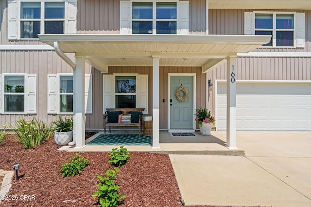 160 James Way, Southport, FL 32409 - property entrance featuring a porch, an attached garage, driveway, and board and batten siding