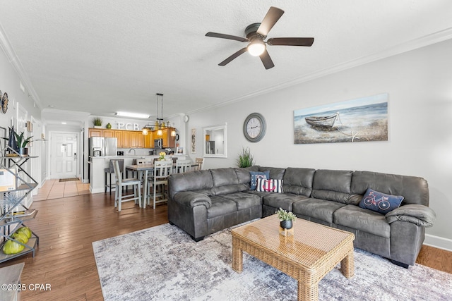 10519 Front Beach Rd Unit 1704B, Panama City Beach, FL 32407 - living room featuring ceiling fan, wood finished floors, ornamental molding, and a textured ceiling