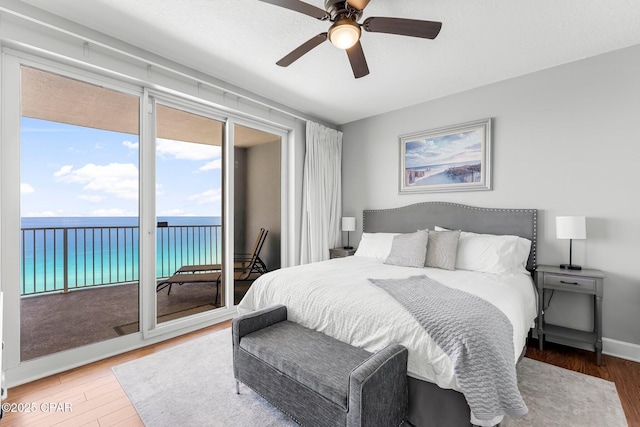 10519 Front Beach Rd Unit 1704B, Panama City Beach, FL 32407 - bedroom with access to exterior, wood finished floors, multiple windows, and a water view